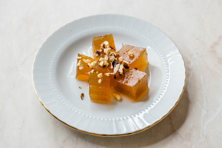Turkish Crispy Pumpkin Dessert from Hatay / Kirecte Kabak Tatlisi with Walnut Powder. Traditional...