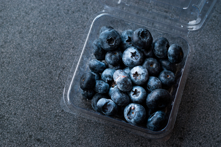 Blueberries / Fresh Raw Organic Berries Blueberry in Plastic Box Package or Container Ready to Eat.の写真素材