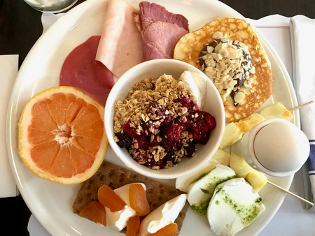 Breakfast Plate with Blackberry Granola, Yogurt, Mozzarella, Pancake, Crispbread, Smoked Beef, Ham and Blood Orange. Traditional Organic Food.の写真素材