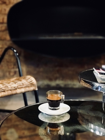 Espresso Coffee Served at Coffee Shop in Front of Fireplace. Organic Hot Beverage.の写真素材