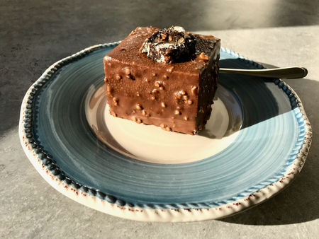 Chocolate Covered Mosaic Biscuit Cake with Hazelnut Powder. Organic Dessert.