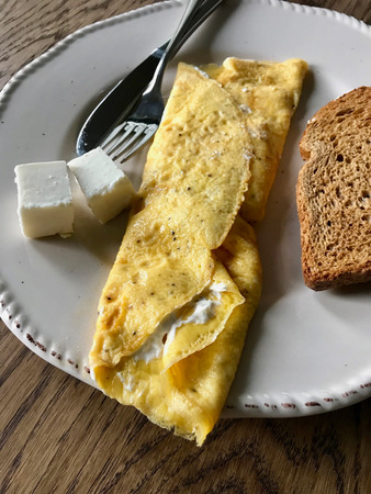 Wrapped Cream Cheese Omelette with Toast Bread for Breakfast. Organic Food.