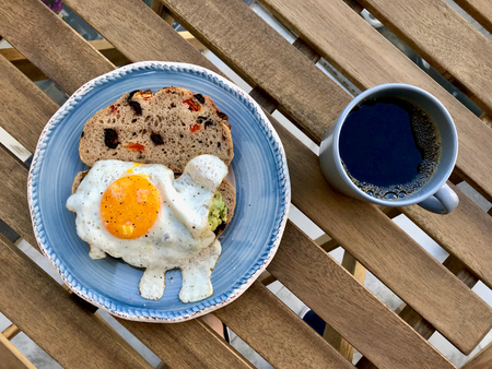 Fried Egg with Avocado on Toast Bread for Breakfast. Organic Food.