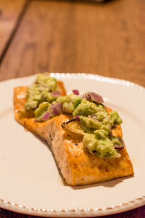 Salmon Fillet with Avocado in Plate at Dinner Table. Organic Seafood.の写真素材