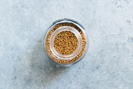 Organic Yellow Mustard Seeds in Glass Jar. Organic Product.