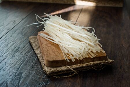 Raw Rice Noodle on Linen Napkin Sack Ready to Use. Organic Traditional Food.の写真素材