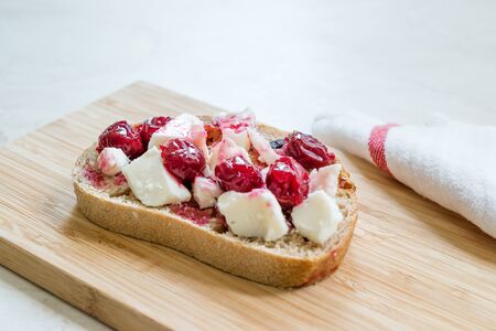 Cherry Jam with Feta Cheese on Bread Slice / Marmalade. Organic Food for Breakfast.の写真素材
