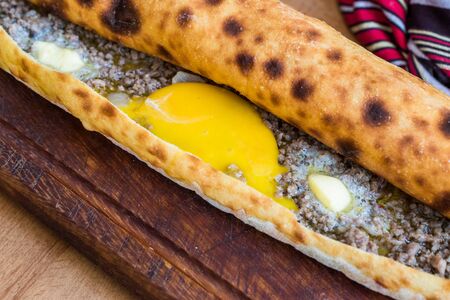 Traditional Turkish Pide at Kebab Restaurant on Wooden Table. Turkish Pizza.の写真素材