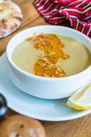 Turkish Lentil Soup with fried butter sauce / Mercimek Corbasi at Restaurant. Organic Traditional Food.の写真素材