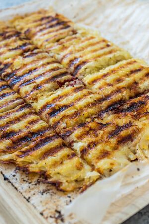 Turkish Toast with Potatoes and Melted Cheese and Sucuk. Traditional Fast Food.の写真素材