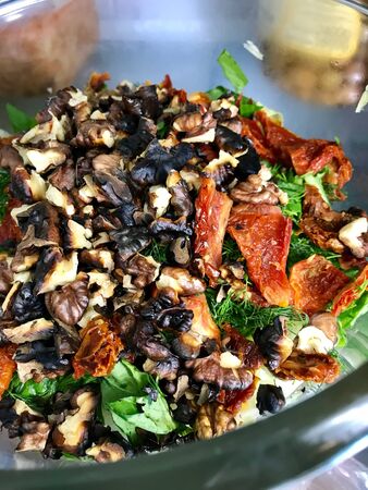Close Up Macro View of Roasted Walnut Salad with Dried Tomatoes in Fridge. Organic Food.の写真素材