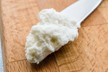 Ricotta Cheese with Knife on Wooden Board Ready to Eat. Traditional Food.の写真素材