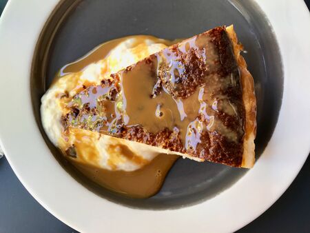 Cheesecake Slice with Dulce De Leche Sauce served in Plate / Milk Jam for Organic Dessert. Ready to...