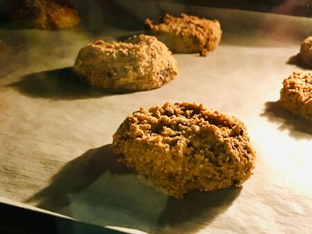 Paleo Chocolate Chip Cookies Made with Coconut and Almond Flour on Baking Paper. Organic Snacks.