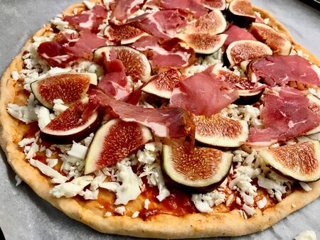 Raw Whole Fig Pizza with Pastrami and Prosciutto. Fast Food.の写真素材