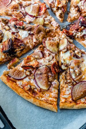 Fig Pizza with Walnut and Sun Dried Tomatoes. Traditional Organic Fast Food.の写真素材