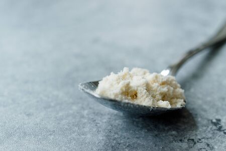 Coconut Flour in Metal Spoon Ready to Use. Organic Product.の写真素材