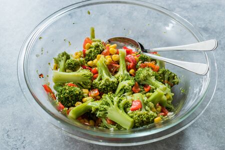 Broccoli Salad with Red Pepper and Corn in Glass Bowl. Organic Food.の写真素材