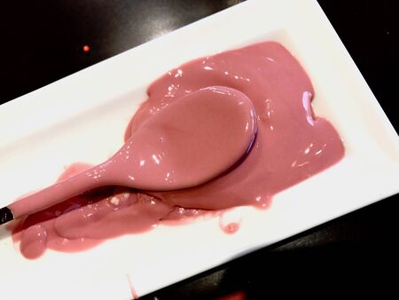 Ruby Chocolate Sauce in Spoon Ready to Pour on Ice Cream or Various Desserts.