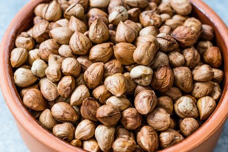 Roasted Macadamia Nuts in Stew Pot. Organic Food.