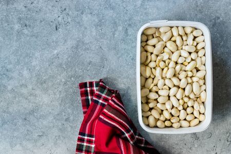 Organic Unsalted White Peeled Raw Peanuts in Plastic Box Container / Package. Organic Food.の写真素材