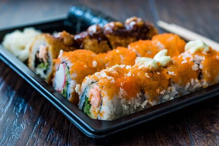 Sushi Set in Plastic Container Box / Package. California Roll, New York Roll, Boom Roll, Ginger, Wasabi and Soy Sauce. Traditional Food.の写真素材