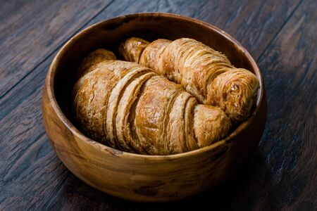 Freshly Baked Croissants in Wooden Bowl. Bakery Concept.