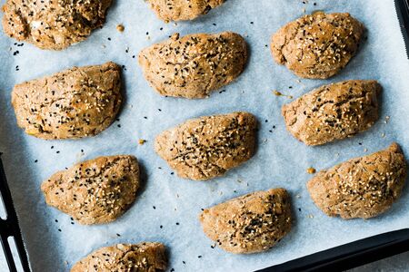 Homemade Turkish Pastries Pogaca made with Karakilcik Wheat, Cheese with Black Cumin Seeds on Baking...