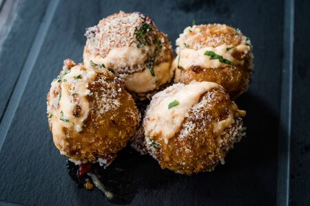 Fried Mac and Cheese Balls with Parmesan Cheese and Mayonnaise / Macaroni Bites. Fast Food.