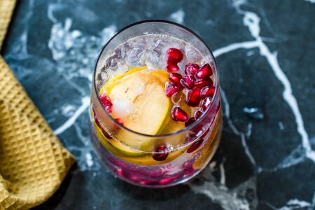 Persimmon Fruit Mocktail / Cocktail with Pomegranate Seeds. Organic Beverage.の写真素材