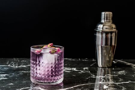 Pink Gin Tonic Cocktail with Dried Rose Buds and Ice in Glass Cup. Ready to Drink.の写真素材