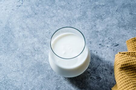 Organic Probiotic Milk Kefir Yogurt in Glass Cup Ready to Drink. Traditional Healhty Beverage.の写真素材