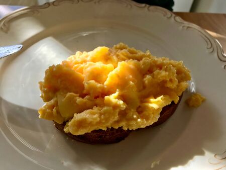 Creamy Scrambled Eggs on Bread with Morning Sunlight / Natural Daylight. Homemade Food.