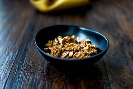 Walnut Kernels and Whole walnuts in Porcelain Bowl.  Organic Food.の写真素材