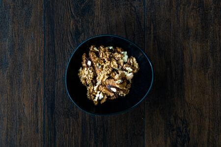 Walnut Kernels and Whole walnuts in Porcelain Bowl.  Organic Food.の写真素材