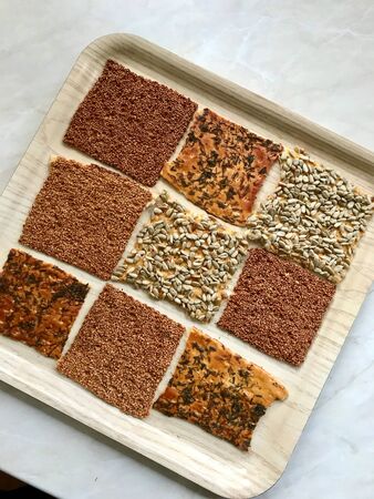 Turkish Homemade Snacks Biscuit with Sunflower Seeds, Sesame and Dill /Crispy Yaprak Galeta with Traditional Tea on Tray. Traditional Food.の写真素材