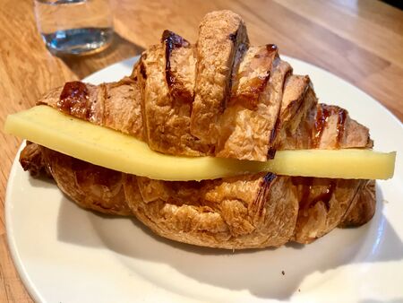 Croissant Sandwich with Cheddar Cheese in Plate at Cafe Restaurant. Ready to Serve and Eat Fast...