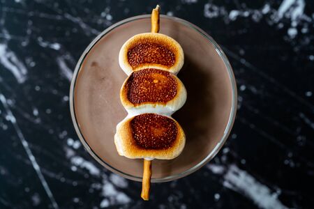 Cooked Marshmallow Cocktail with Pretzel Sticks  also Called Sweet Baby or Babyccino. Confectionery...