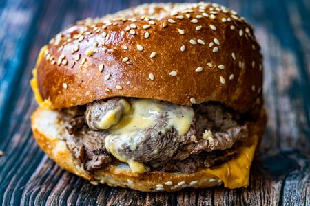 Steak Burger made with Lamb Meat Lokum and Cheddar Cheese / Hamburger or Cheeseburger on Wooden Surface. Fast Food.の写真素材