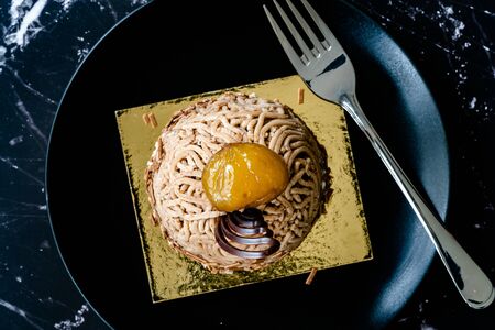 French Traditional Cake "Mont Blanc" with Chestnuts Cream / Chestnut served with Black Plate.の写真素材
