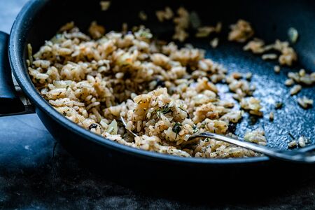 Turkish Stuffed Rice with Currants for Preparing Dolma in Pan with Spoon / Pilav or Pilaf. Traditional Food.の写真素材