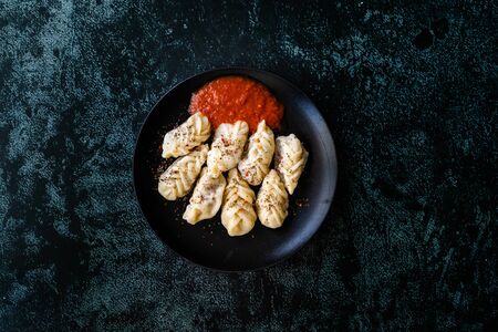 Georgian Dumplings Khinkali with Meat, Tomato Sauce and Spices / Hingel. Traditional Dish.の写真素材