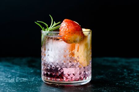 Fruit Cocktail with Strawberry, Mandarin, Apple and Rosemary / Fresh Pink Punch Beverage. Summer Drink.の写真素材