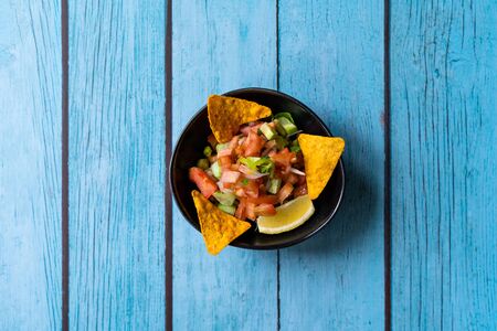 Mexican Food Pico De Gallo Salsa Salad with Tortilla Nachos, Tomato, Onion, Lime, Cilantro, Parsley,...