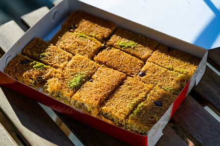 Take Away Turkish Dessert Kadayif with Pistachio Powder in Plastic Boxの写真素材