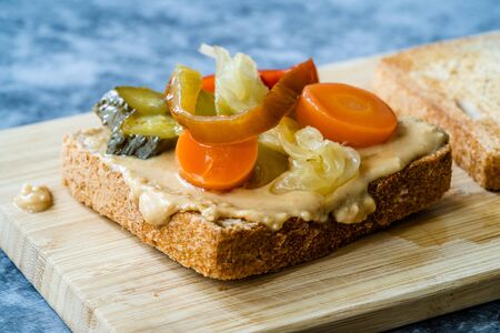 Organic Healthy Homemade Peanut Butter and Pickle Sandwich on Wooden Board. Ready to Eat.の写真素材