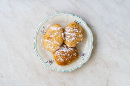 Mandazi is a slightly sweet East African Street Food; spicy, airy yeast doughnut dough made with coconut milk, flavored with cardamom and grated fresh coconut. Traditional Dish.の写真素材