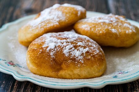 Mandazi is a slightly sweet East African Street Food; spicy, airy yeast doughnut dough made with...