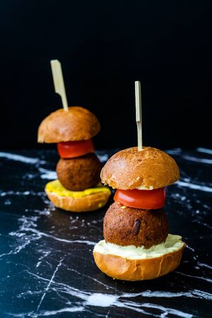 Homemade Mediterranean Mini Falafel Vegan Burger with Tzatziki and Turmeric Sauce. Starter Food with...