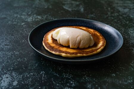 Poached Egg with Pancake in Plate for Breakfast. Healthy Organic Food.